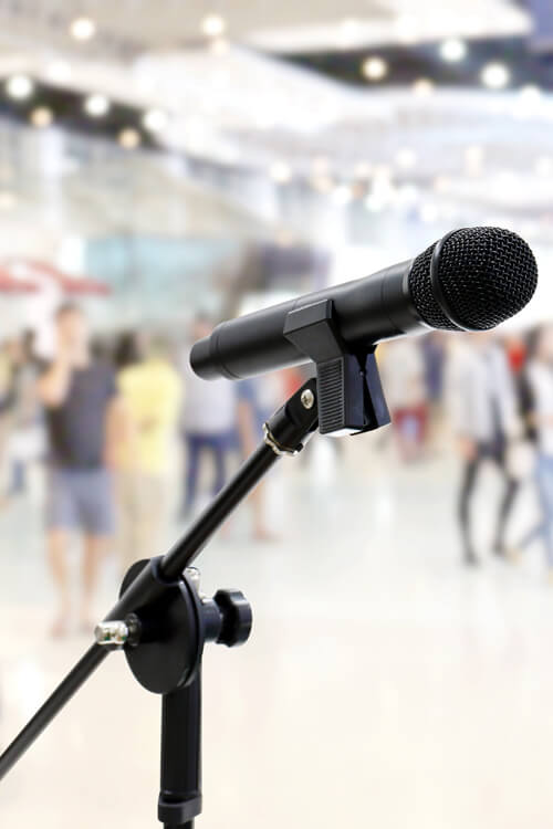 Microphone Public Relations On Blurred Many People Within Depart